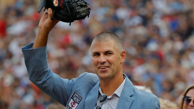 Joe Mauer waves with mitt